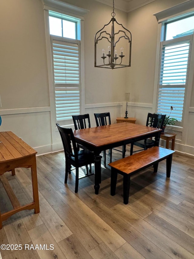311 Villager Ave Unit C, Scott, LA 70583 - dining room with a chandelier, light wood-style floors, ornamental molding, plenty of natural light, and wainscoting