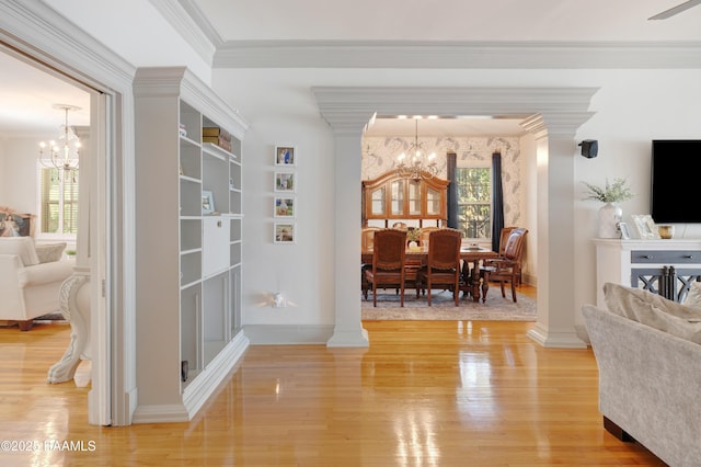 303 Duperier Ave, New Iberia, LA 70563 - living area with a chandelier, light wood-style floors, crown molding, and ornate columns