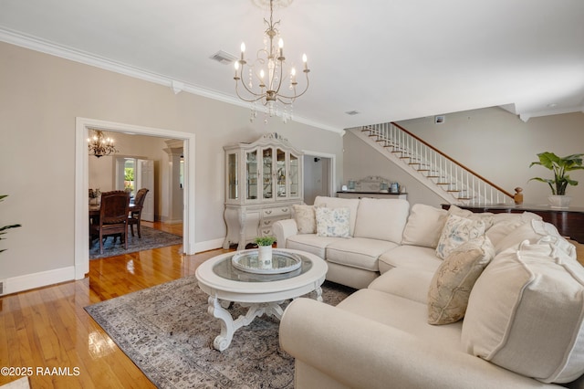 303 Duperier Ave, New Iberia, LA 70563 - living area featuring a chandelier, crown molding, stairs, baseboards, and light wood-type flooring