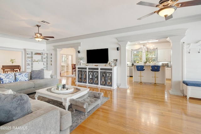 303 Duperier Ave, New Iberia, LA 70563 - living room featuring a ceiling fan, decorative columns, light wood finished floors, plenty of natural light, and ornamental molding