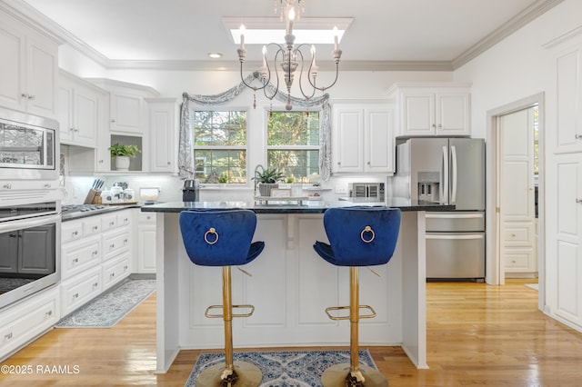 303 Duperier Ave, New Iberia, LA 70563 - kitchen featuring appliances with stainless steel finishes, a kitchen island, a breakfast bar area, white cabinetry, and recessed lighting