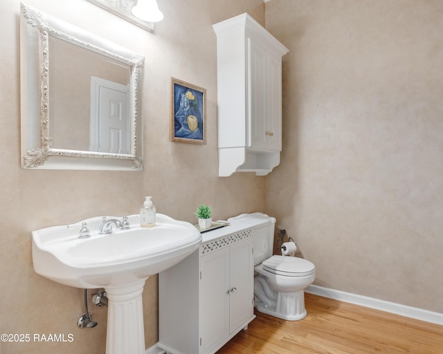 303 Duperier Ave, New Iberia, LA 70563 - half bathroom with toilet, wood finished floors, and baseboards
