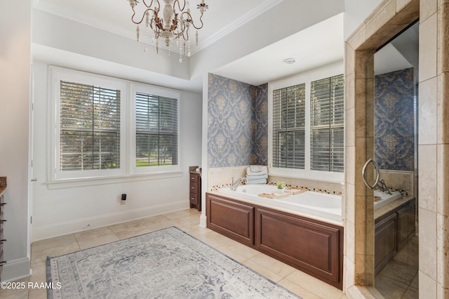 303 Duperier Ave, New Iberia, LA 70563 - full bath with tile patterned flooring, a garden tub, a chandelier, crown molding, and baseboards