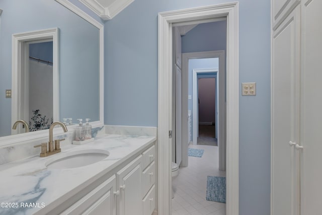 303 Duperier Ave, New Iberia, LA 70563 - bathroom featuring toilet, vanity, tile patterned flooring, and crown molding