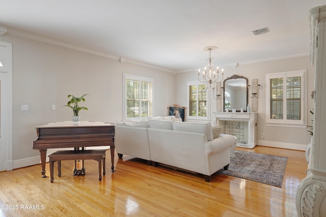 303 Duperier Ave, New Iberia, LA 70563 - living room with a chandelier, light wood-type flooring, crown molding, and baseboards