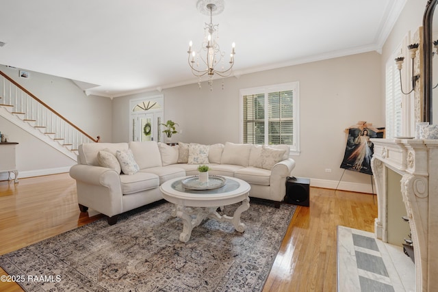 303 Duperier Ave, New Iberia, LA 70563 - living area with light wood finished floors, stairs, ornamental molding, a chandelier, and baseboards