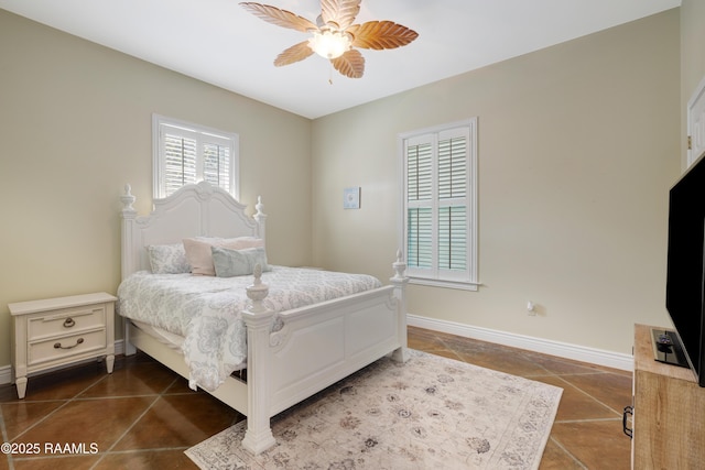 303 Duperier Ave, New Iberia, LA 70563 - bedroom featuring dark tile patterned flooring, baseboards, and a ceiling fan