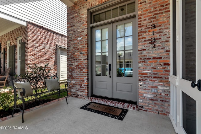 3132 Veranda View Ave, Baton Rouge, LA 70810 - property entrance with french doors, brick siding, and covered porch