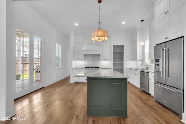 3132 Veranda View Ave, Baton Rouge, LA 70810 - kitchen featuring appliances with stainless steel finishes, crown molding, white cabinets, a center island, and light wood-style floors