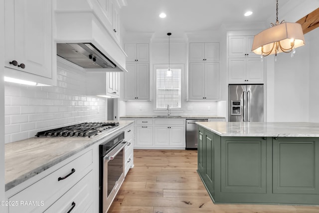 3132 Veranda View Ave, Baton Rouge, LA 70810 - kitchen featuring stainless steel appliances, exhaust hood, a sink, white cabinets, and light wood finished floors
