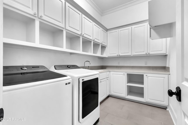 3132 Veranda View Ave, Baton Rouge, LA 70810 - laundry area featuring separate washer and dryer, ornamental molding, light tile patterned floors, and cabinet space