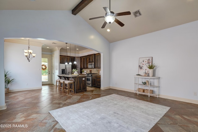 109 Flamingo Row, Lafayette, LA 70508 - living area with a chandelier, stone tile flooring, a ceiling fan, arched walkways, and beam ceiling