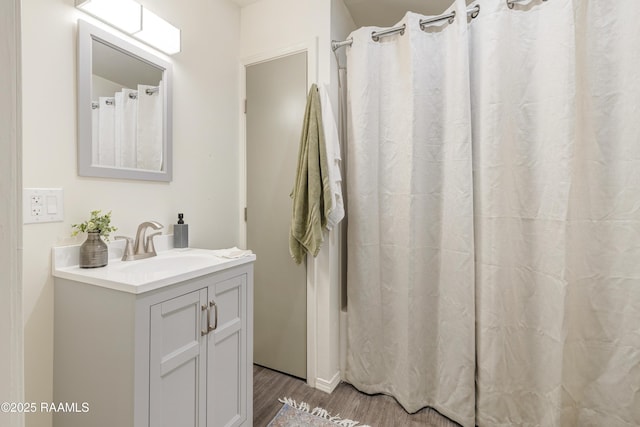 531 Silver St, New Iberia, LA 70560 - bathroom with wood finished floors, vanity, and a shower with curtain