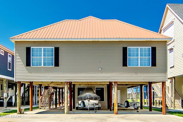 178 Flounder Ct, Dulac, LA 70353 - back of house with a carport, stairs, metal roof, and driveway