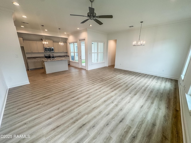 305 Berchman Oaks Dr, Lafayette, LA 70506 - unfurnished living room with crown molding, wood finished floors, baseboards, a chandelier, and recessed lighting