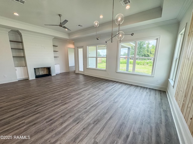 219 Timber Mill St, Lafayette, LA 70508 - unfurnished living room featuring crown molding, a tray ceiling, dark wood finished floors, ceiling fan, and a fireplace