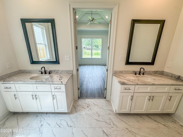 219 Timber Mill St, Lafayette, LA 70508 - full bathroom with marble look tile flooring, two vanities, a ceiling fan, and baseboards