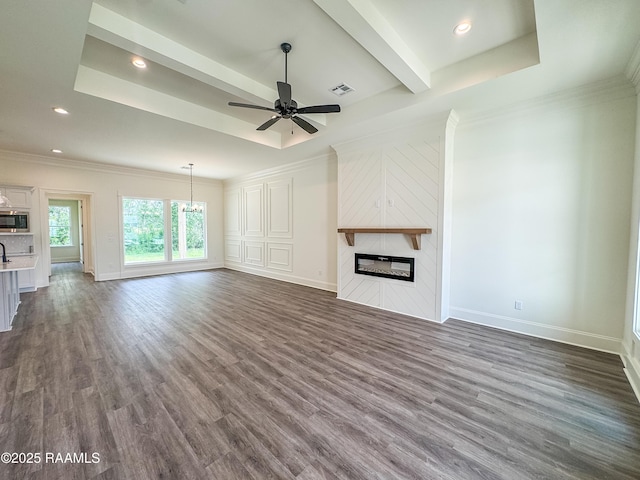 222 Timber Mill St, Lafayette, LA 70508 - unfurnished living room with a large fireplace, ceiling fan, dark wood finished floors, baseboards, and a chandelier