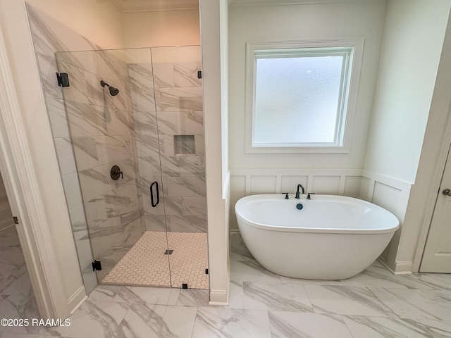 222 Timber Mill St, Lafayette, LA 70508 - full bathroom featuring marble look tiles, a freestanding bath, a shower stall, a wainscoted wall, and a decorative wall