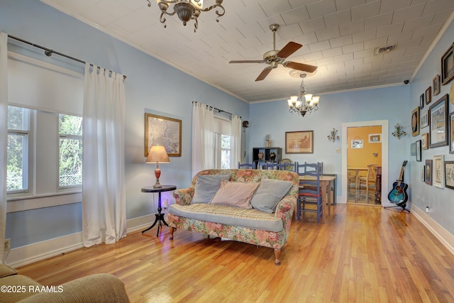 519 Mudd Ave, Lafayette, LA 70501 - living room featuring a chandelier, crown molding, light wood-style flooring, ceiling fan, and baseboards