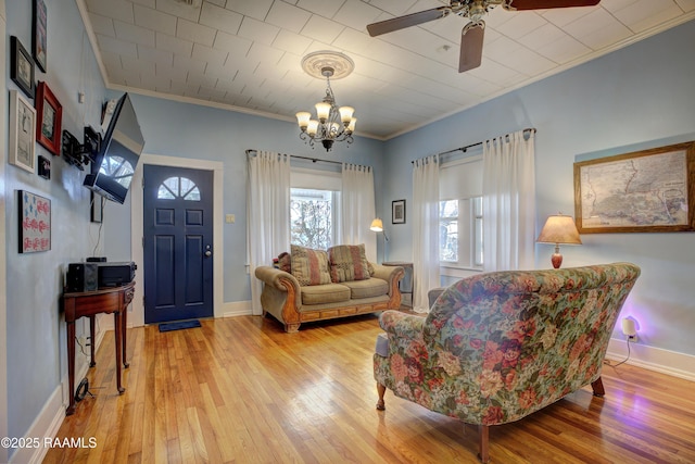 519 Mudd Ave, Lafayette, LA 70501 - living area featuring crown molding, light wood-type flooring, a ceiling fan, a chandelier, and baseboards