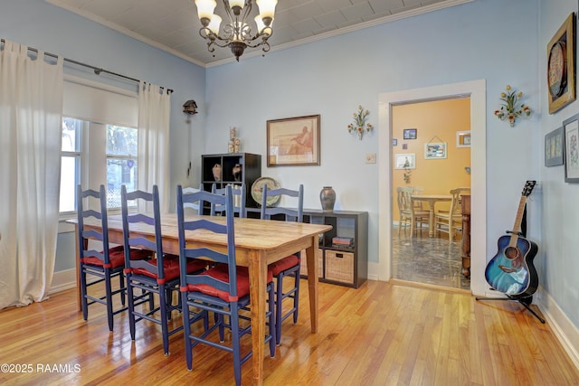 519 Mudd Ave, Lafayette, LA 70501 - dining area featuring a chandelier, crown molding, light wood finished floors, and baseboards