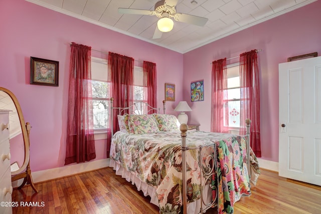 519 Mudd Ave, Lafayette, LA 70501 - bedroom with multiple windows, hardwood / wood-style floors, crown molding, and baseboards