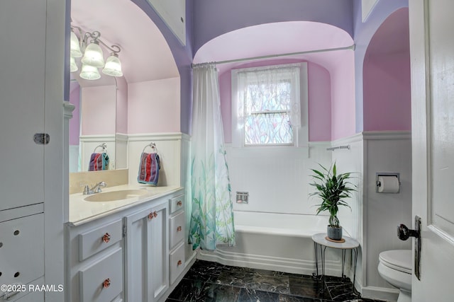 519 Mudd Ave, Lafayette, LA 70501 - bathroom featuring wainscoting, toilet, vanity, marble finish flooring, and shower / bath combination with curtain