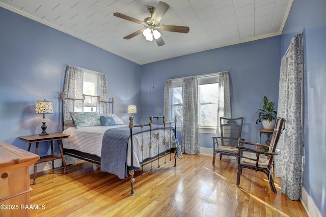 519 Mudd Ave, Lafayette, LA 70501 - bedroom with wood finished floors, crown molding, baseboards, and a ceiling fan