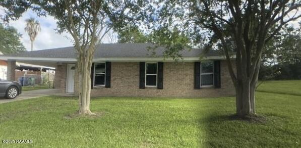 13734 Wilda Dr, Kaplan, LA 70548 - single story home featuring an attached carport, concrete driveway, and a front lawn