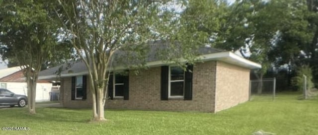 13734 Wilda Dr, Kaplan, LA 70548 - view of front of property featuring a front lawn, brick siding, and a garage