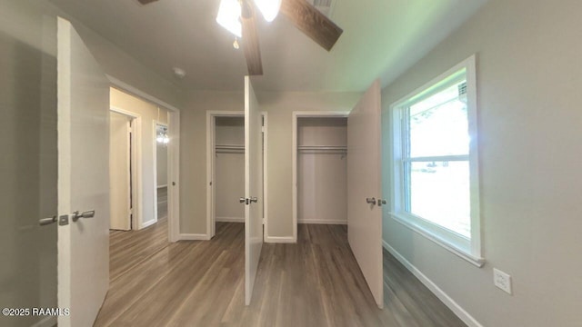 13734 Wilda Dr, Kaplan, LA 70548 - unfurnished bedroom with baseboards, wood finished floors, and multiple windows