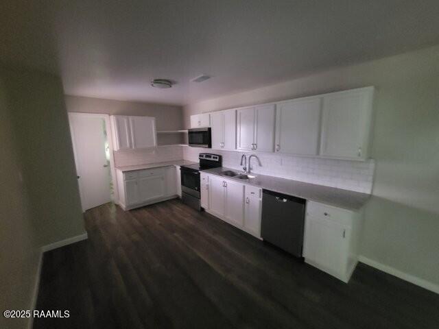 13734 Wilda Dr, Kaplan, LA 70548 - kitchen with range with electric cooktop, dishwashing machine, white cabinets, backsplash, and dark wood-type flooring