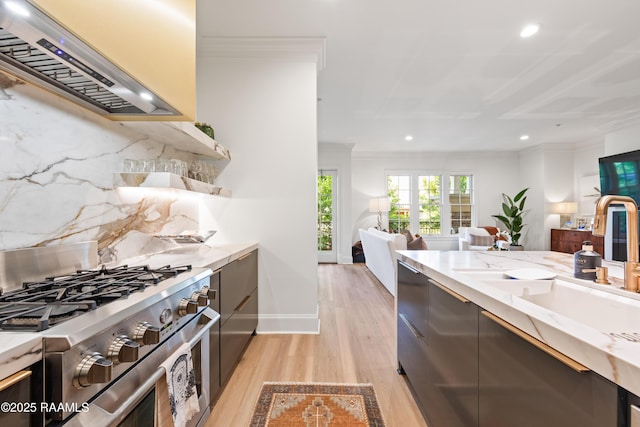 302 Richland Ave Unit 207C, Lafayette, LA 70508 - kitchen with stainless steel gas range oven, wall chimney exhaust hood, crown molding, light wood finished floors, and recessed lighting
