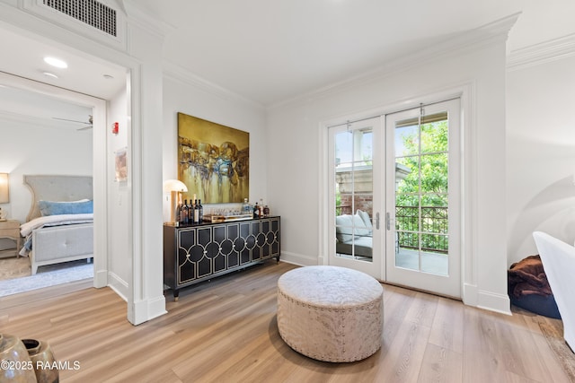 302 Richland Ave Unit 207C, Lafayette, LA 70508 - sitting room with wood finished floors, crown molding, french doors, baseboards, and bar
