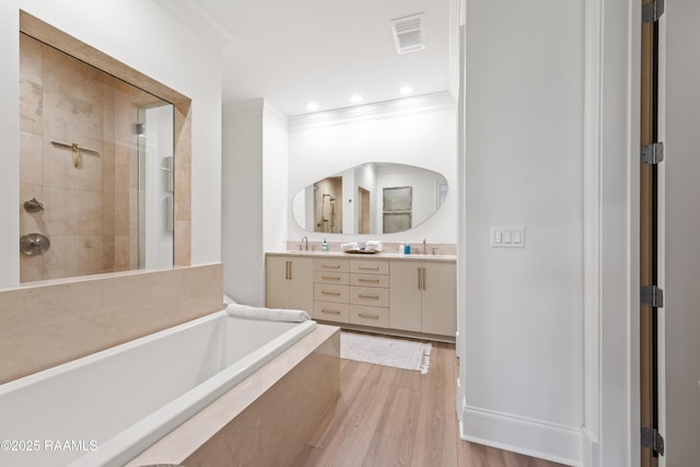 302 Richland Ave Unit 207C, Lafayette, LA 70508 - bathroom with ornamental molding, double vanity, a bath, tiled shower, and wood finished floors