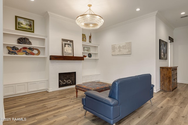 308 Manor House Ln, Lafayette, LA 70507 - living room featuring light wood-style floors, a chandelier, crown molding, recessed lighting, and built in features