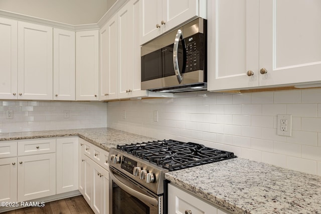 308 Manor House Ln, Lafayette, LA 70507 - kitchen with stainless steel appliances, white cabinets, tasteful backsplash, and light stone countertops