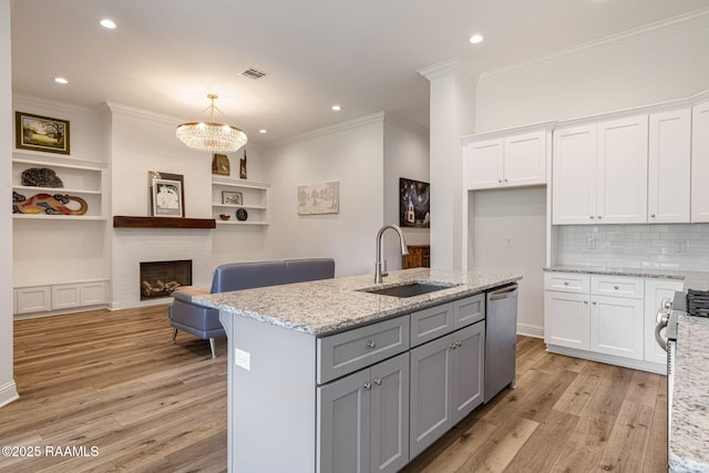 308 Manor House Ln, Lafayette, LA 70507 - kitchen featuring stainless steel dishwasher, a sink, gray cabinets, light wood-style floors, and white cabinetry