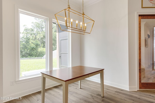 308 Manor House Ln, Lafayette, LA 70507 - unfurnished dining area with a chandelier, baseboards, wood finished floors, and crown molding