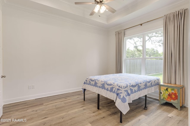 308 Manor House Ln, Lafayette, LA 70507 - bedroom featuring light wood-type flooring, ornamental molding, baseboards, ceiling fan, and a tray ceiling