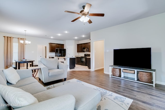 118 Barnet Ct, Lafayette, LA 70507 - living room featuring a chandelier, ceiling fan, light wood-style flooring, recessed lighting, and baseboards