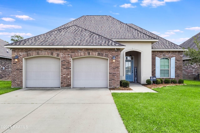 311 Victoria Lights Ln, Broussard, LA 70518 - french provincial home featuring a shingled roof, driveway, an attached garage, brick siding, and a front yard