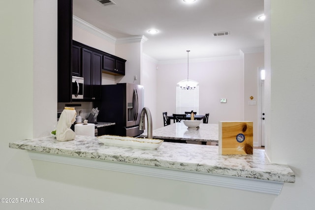 311 Victoria Lights Ln, Broussard, LA 70518 - kitchen with appliances with stainless steel finishes, ornamental molding, a chandelier, hanging light fixtures, and light stone countertops