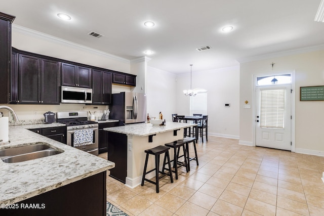 311 Victoria Lights Ln, Broussard, LA 70518 - kitchen featuring stainless steel appliances, a sink, a kitchen breakfast bar, a chandelier, and ornamental molding