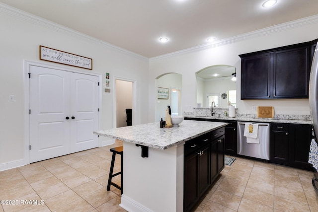 311 Victoria Lights Ln, Broussard, LA 70518 - kitchen with stainless steel dishwasher, ornamental molding, a kitchen bar, light tile patterned flooring, and a ceiling fan