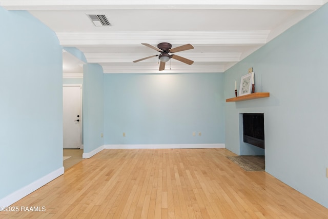 1008 S College Rd Unit 205, Lafayette, LA 70503 - unfurnished living room with a fireplace, a ceiling fan, beamed ceiling, hardwood / wood-style floors, and baseboards