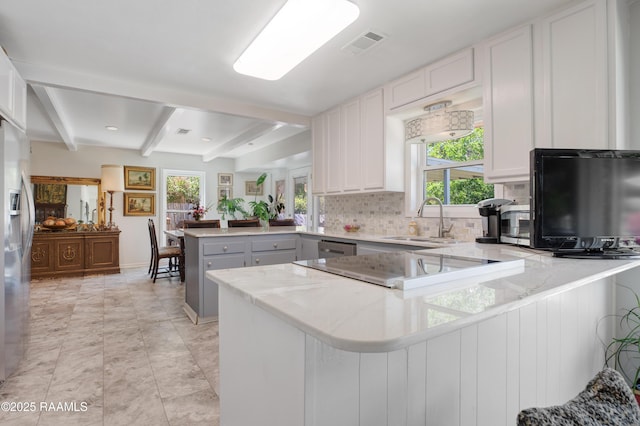 113 Templeton Dr, Lafayette, LA 70508 - kitchen with a peninsula, a sink, backsplash, healthy amount of natural light, and beam ceiling