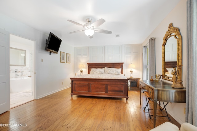113 Templeton Dr, Lafayette, LA 70508 - bedroom featuring light wood-type flooring, multiple windows, baseboards, and ensuite bathroom