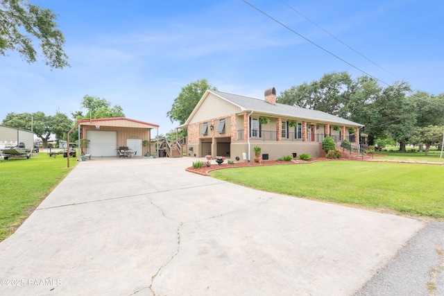 507 W Laodis St, Delcambre, LA 70528 - ranch-style house with a detached garage, an outbuilding, a front yard, a chimney, and concrete driveway